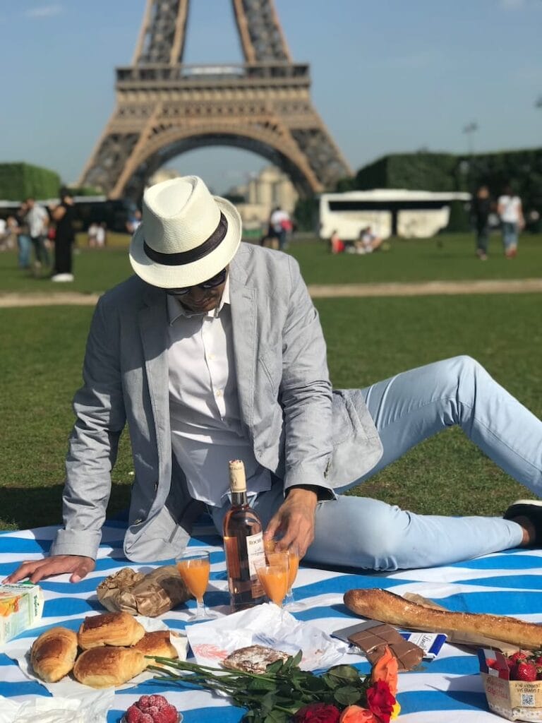 Pericles Rosa setting up a picnic at Champ de Mars, Paris, France