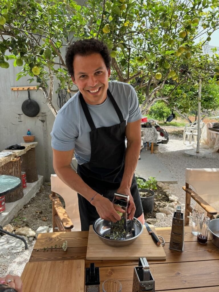 Pericles Rosa wearing an apron during a cooking class at Perivoli Farm, Naxos, Greece